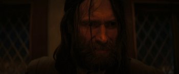 Movie still from “Fear Street: Part Three - 1666” (2021), directed by Leigh Janiak – A man with long hair and a long beard; Close Up shot, Over the shoulder angle