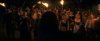 Movie still from “Fear Street: Part Three - 1666” (2021), directed by Leigh Janiak – A group of people are holding torches in the dark; Wide shot, High angle