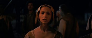 Movie still from “Fear Street: Part Three - 1666” (2021), directed by Leigh Janiak – A woman wearing a hat standing next to other people; Close Up shot, Over the shoulder angle