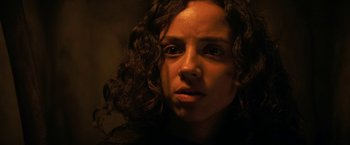Movie still from “Fear Street: Part Three - 1666” (2021), directed by Leigh Janiak – A person with curly hair; Close Up shot, Low angle