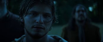 Movie still from “Fear Street: Part Three - 1666” (2021), directed by Leigh Janiak – A person with a dark background; Close Up shot, Low angle