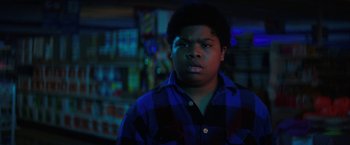 Movie still from “Fear Street: Part Three - 1666” (2021), directed by Leigh Janiak – A young man in a plaid shirt stares into the camera; Close Up shot, Low angle