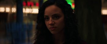 Movie still from “Fear Street: Part Three - 1666” (2021), directed by Leigh Janiak – A person with long curly hair; Close Up shot, Over the shoulder angle