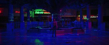 Movie still from “Fear Street: Part Three - 1666” (2021), directed by Leigh Janiak – A person standing in a neon lit area; Extreme Wide shot, Low angle