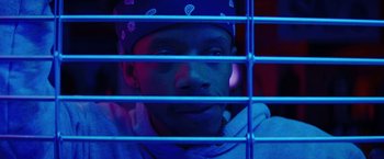 Movie still from “Fear Street: Part Three - 1666” (2021), directed by Leigh Janiak – A man with a bandanna on his head is behind bars; Close Up shot, Low angle