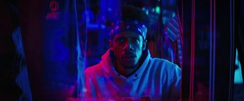Movie still from “Fear Street: Part Three - 1666” (2021), directed by Leigh Janiak – A young man wearing a white sweatshirt and a purple headband; Close Up shot, Low angle