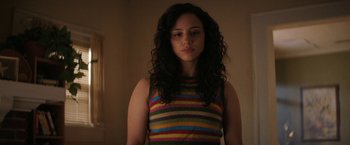 Movie still from “Fear Street: Part Three - 1666” (2021), directed by Leigh Janiak – A woman with long black curly hair wearing a striped shirt; Close Up shot, Low angle