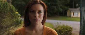 Movie still from “Fear Street: Part Three - 1666” (2021), directed by Leigh Janiak – A person wearing a yellow sweater; Close Up shot, Low angle