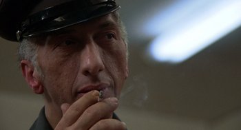 Movie still from “Midnight Express” (1978), directed by Alan Parker – A person smoking a cigarette; Close Up shot, Low angle
