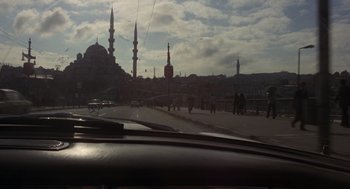 Movie still from “Midnight Express” (1978), directed by Alan Parker – A view from a car window of a city street with a mosque in the background; Extreme Wide shot, Low angle