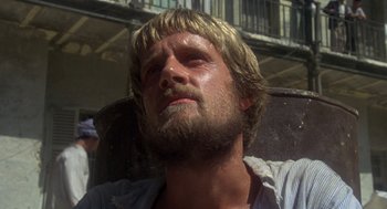 Movie still from “Midnight Express” (1978), directed by Alan Parker – A person with long hair and a beard; Close Up shot, Low angle