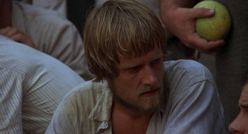 Movie still from “Midnight Express” (1978), directed by Alan Parker – A person with long hair and a beard; Close Up shot, High angle