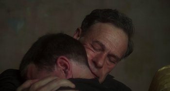 Movie still from “Midnight Express” (1978), directed by Alan Parker – A man is hugging another man with his eyes closed; Close Up shot, High angle