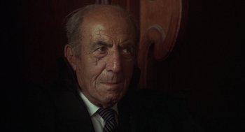 Movie still from “Midnight Express” (1978), directed by Alan Parker – An old man wearing a suit and tie; Close Up shot, Low angle