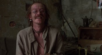 Movie still from “Midnight Express” (1978), directed by Alan Parker – A man with a beard and glasses is smiling for the camera; Close Up shot, Low angle