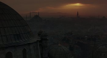 Movie still from “Midnight Express” (1978), directed by Alan Parker – A view of a city skyline at sunset; Extreme Wide shot, High angle