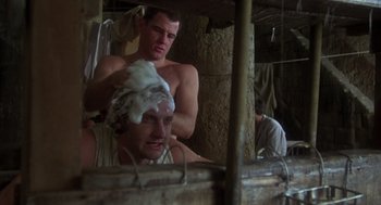 Movie still from “Midnight Express” (1978), directed by Alan Parker – A man is shaving another man's head; Close Up shot, Low angle