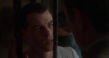 Movie still from “Midnight Express” (1978), directed by Alan Parker – A man looking at another man in a mirror; Close Up shot, Over the shoulder angle