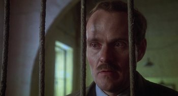 Movie still from “Midnight Express” (1978), directed by Alan Parker – A person behind a fence; Close Up shot, Low angle