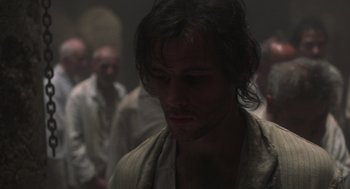 Movie still from “Midnight Express” (1978), directed by Alan Parker – A person wearing a robe in a dark room; Close Up shot, Low angle