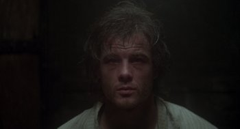 Movie still from “Midnight Express” (1978), directed by Alan Parker – A person wearing a white shirt; Close Up shot, Low angle