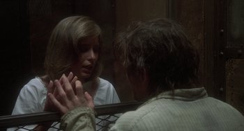 Movie still from “Midnight Express” (1978), directed by Alan Parker – A man and a woman looking at each other in a mirror; Close Up shot, Over the shoulder angle