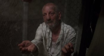 Movie still from “Midnight Express” (1978), directed by Alan Parker – An old man sitting in front of a window; Close Up shot, High angle