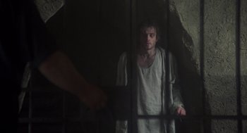 Movie still from “Midnight Express” (1978), directed by Alan Parker – A man standing in front of a jail cell; Medium shot, Low angle