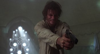 Movie still from “Midnight Express” (1978), directed by Alan Parker – A man holding a gun in his hand; Close Up shot, Low angle