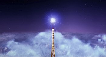 Movie still from “Mighty Joe Young” (1998), directed by Ron Underwood – A tall tower with a bright light shining on it; Extreme Wide shot, Low angle