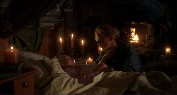 Movie still from “Mighty Joe Young” (1998), directed by Ron Underwood – A woman is laying in bed with a child; Medium shot, Over the shoulder angle