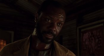 Movie still from “Mighty Joe Young” (1998), directed by Ron Underwood – A person wearing a jacket; Close Up shot, Over the shoulder angle