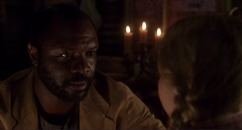 Movie still from “Mighty Joe Young” (1998), directed by Ron Underwood – A man and a woman sitting in front of candles; Close Up shot, Over the shoulder angle