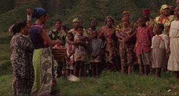 Movie still from “Mighty Joe Young” (1998), directed by Ron Underwood – A group of women and children standing in a grassy area; Extreme Wide shot, High angle
