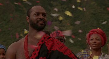 Movie still from “Mighty Joe Young” (1998), directed by Ron Underwood – A man and a woman standing next to each other in front of confetti; Close Up shot, Low angle