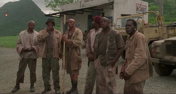 Movie still from “Mighty Joe Young” (1998), directed by Ron Underwood – A group of men standing next to each other on a street; Medium shot, High angle