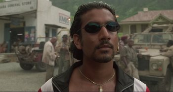 Movie still from “Mighty Joe Young” (1998), directed by Ron Underwood – A person wearing sunglasses; Close Up shot, Low angle