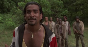 Movie still from “Mighty Joe Young” (1998), directed by Ron Underwood – A group of men standing next to each other in a forest; Close Up shot, Low angle