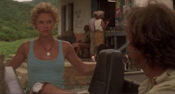 Movie still from “Mighty Joe Young” (1998), directed by Ron Underwood – A woman sitting at a table in front of a man; Medium shot, Over the shoulder angle