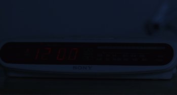 Movie still from “Mighty Joe Young” (1998), directed by Ron Underwood – A digital alarm clock that is lit up at 2 : 0 0; Extreme Close Up shot, High angle