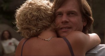 Movie still from “Mighty Joe Young” (1998), directed by Ron Underwood – A man and a woman embracing each other; Close Up shot, Over the shoulder angle