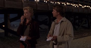 Movie still from “Mighty Joe Young” (1998), directed by Ron Underwood – A man and a woman standing next to each other; Medium shot, Over the shoulder angle