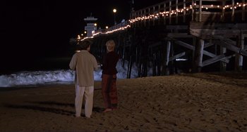 Movie still from “Mighty Joe Young” (1998), directed by Ron Underwood – Two people standing on the beach at night; Wide shot, High angle