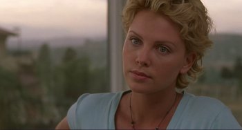 Movie still from “Mighty Joe Young” (1998), directed by Ron Underwood – Charlize theron in a scene from the movie; Close Up shot, Over the shoulder angle