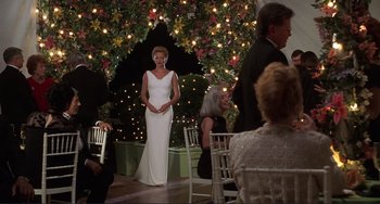 Movie still from “Mighty Joe Young” (1998), directed by Ron Underwood – A woman in a white dress standing in front of a christmas tree; Wide shot, Over the shoulder angle
