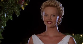 Movie still from “Mighty Joe Young” (1998), directed by Ron Underwood – A woman with blonde hair and red lipstick; Close Up shot, Low angle