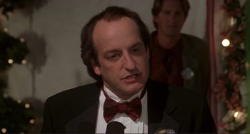 Movie still from “Mighty Joe Young” (1998), directed by Ron Underwood – A man wearing a suit and a red bow tie; Close Up shot, Low angle