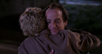 Movie still from “Mighty Joe Young” (1998), directed by Ron Underwood – A man and a woman hugging each other in the dark; Close Up shot, Over the shoulder angle