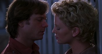 Movie still from “Mighty Joe Young” (1998), directed by Ron Underwood – A man and a woman face to face in front of a curtain; Close Up shot, Low angle