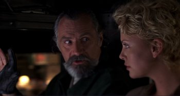 Movie still from “Mighty Joe Young” (1998), directed by Ron Underwood – A man and a woman looking at each other in the dark; Close Up shot, Over the shoulder angle